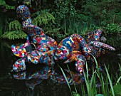 SCULPTURE BY TONY HEYWOOD FLOATING ON WATER IN THE WATER GARDENS  LONDON