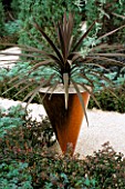 COPPER CONICAL CONTAINER WITH BRONZE PHORMIUM IN THE DAILY TELEGRAPHS WRONG GARDEN