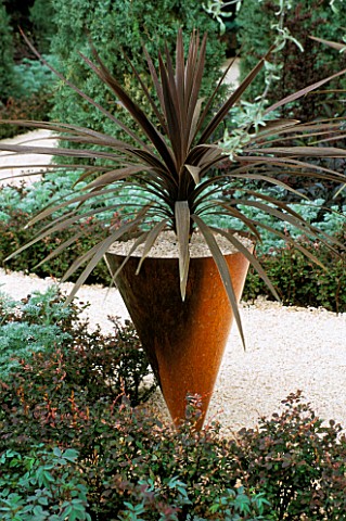 COPPER_CONICAL_CONTAINER_WITH_BRONZE_PHORMIUM_IN_THE_DAILY_TELEGRAPHS_WRONG_GARDEN