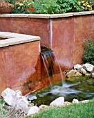 PETERSFIELD GARDEN WATER FEATURE: RENDERED CONCRETE WALL  RILL AND WATER FEATURE. DESIGNER: MARK LAURENCE