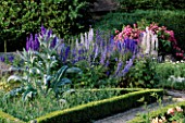 THE PRIORY  BEECH HILL  BERKSHIRE: AMERICAN PILLAR ROSE TRAINED OVER TRELLIS  DELPHINIUMS AND CARDOON IN TRIANGULAR PICKING BED