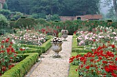 THE PRIORY  BEECH HILL  BERKSHIRE: THE NEW ROSE PARTERRE WITH BOX EDGING  STONE URN WITH PHORMIUM AND WHITE BEGONIAS  YEW HEDGING AND GRAVEL PATHS
