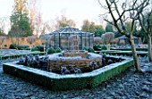 WEST GREEN HOUSE GARDEN  HAMPSHIRE: CLIPPED BOX HEDGING IN THE POTAGER WITH AN OLD METAL FRUIT CAGE IN THE BACKGROUND IN WINTER IN FROST