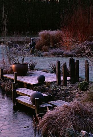WOODEN_LANDING_STAGES_WITH_CONTAINER__STONE_BALLS_AND_ROCKS_IN_FROST_BESIDE_THE_POOL_JOHN_MASSEYS_GA
