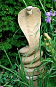 WOODCHIPPINGS  NORTHANTS: STONE COBRA FLANKING THE YEW ARCH