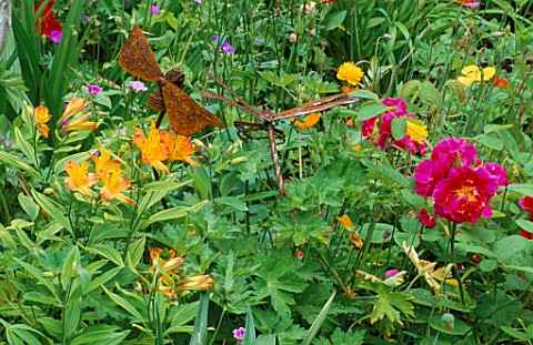 WOODCHIPPINGS__NORTHANTS_RUSTY_METAL_DRAGONFLY_AMONGST_ALSTROEMERIAS_AND_ROSA_DUCHESS_OF_PORTLAND