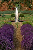 DOWNDERRY NURSERY  KENT: PATH LINED WITH LAVENDER TO OBELISK WATER FEATURE AND MIRROR ON WALL