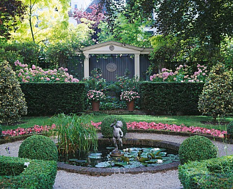 AMSTERDAM_PRIVATE_GARDEN_WITH_BOX_HEDGING__SUMMERHOUSE__CLIPPED_HOLLIES__BEDDING_BEGONIAS__POOL_AND_