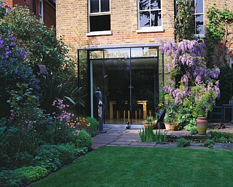 DESIGNER_SHEILA_STEDMAN__VIEW_OF_LAWN_AND_BACK_OF_HOUSE_WITH_RECTANGULAR_POOL__WISTERIA__GLASS_FRONT