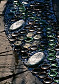 RECYCLED BOTTLES  GLASS PEBBLES ON CIRCULAR PAVED PATH. DESIGNER: DAVID CHASE