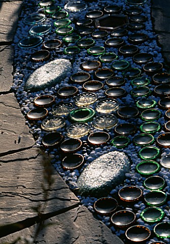RECYCLED_BOTTLES__GLASS_PEBBLES_ON_CIRCULAR_PAVED_PATH_DESIGNER_DAVID_CHASE