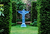 THE ABBEY HOUSE  WILTSHIRE: YEW HEDGES WITH VIEW TO BRONZE RESIN SCULPTURE OF ST FRANCIS OF ASSISI BY BILL HARLING
