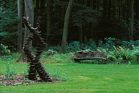 SLATE__SCULPTURE_AND_WOODEN_BENCH_IN_THE_WOODLAND_DESIGNER_DUNCAN_HEATHER__GREYSTONE_COTTAGE__OXFORD