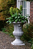 URN IN FRONT OF HOUSE PLANTED WITH EUCOMIS. PARSONAGE  OMBERSLEY  WORCESTERSHIRE
