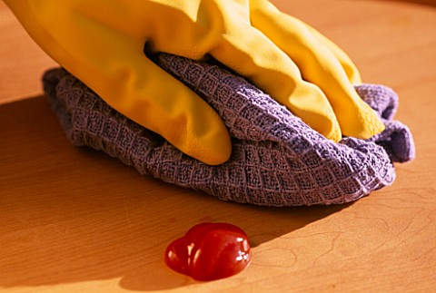 HAND_IN_RUBBER_GLOVE_WITH_CLOTH_CLEANING_UP_KETCHUP