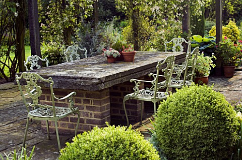 JANET_CROPLEY_GARDEN__HILL_GROUNDS__NORTHAMPTONSHIRE_STONE_TABLE__VARIEGATED_BOX_BALLS