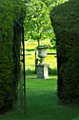 VIEW THROUGH YEW HEDGES TO STONE URN ON PEDESTAL. JANET CROPLEY GARDEN  HILL GROUNDS  NORTHAMPTONSHIRE