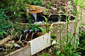 WATER FEATURE: RILL SPILLING INTO A CIRCULAR STONE BASIN AND OUT AGAIN THROUGH THREE PIPES INTO ANOTHER RILL.WINGWELL NURSERY   RUTLAND