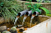 WATER FEATURE: THREE PIPES SPILLING WATER INTO A RILL. WINGWELL NURSERY   RUTLAND