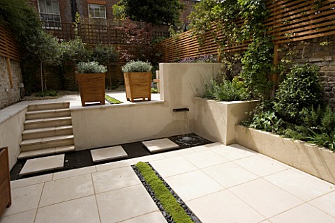 VIEW_ACROSS_CONTEMPORARY_GARDEN_WITH_PLANTED_RILL__COPPER_WATER_FEATURE__STEPS_AND_TWO__WOODEN_CONTA