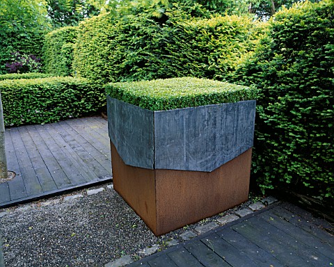 RIDLERS_GARDEN__SWANSEA__WALES_LEAD_AND_RUSTY_METAL_CONTAINER_PLANTED_WITH_BOX_TABLE__DESIGNER_TONY_