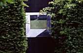 RIDLERS GARDEN  SWANSEA  WALES: BLACK WALL WITH PICTURE BETWEEN TWO YEW HEDGES. DESIGNER: TONY RIDLER