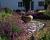 CLARE MATTHEWS GARDEN  DEVON: NEPETA WALKERS LOW  SLATE AND A LARGE URN (CONTAINER) BESIDE THE HOUSE
