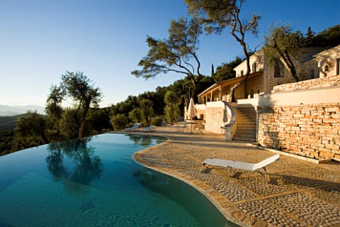 VIEW_OF_THE_HOUSE_WITH__OLIVE_TREES_AND_INFINITY_SWIMMING_POOL_IN_THE_FOREGROUND_GINA_PRICES_GARDEN_