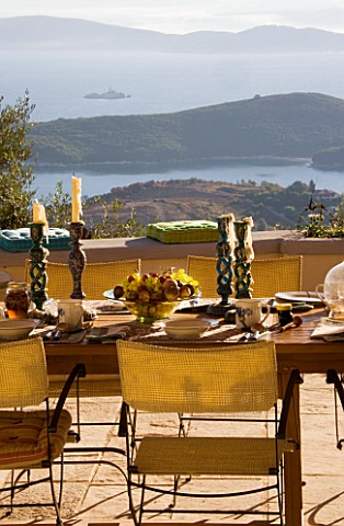 VIEW_OVER_TABLE_WITH_FRUIT_BOWL_TO_IONIAN_SEA_ISLAND_OF_CORFU__GINA_PRICES_GARDEN