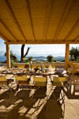 GINA PRICES GARDEN  CORFU: VIEW FROM THE TERRACE ACROSS THE TABLE TO THE IONIAN SEA AND ALBANIAN MOUNTAINS