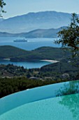 GINA PRICES GARDEN  CORFU: VIEW ACROSS THE INFINITY POOL TO THE IONIAN SEA AND ALBANIAN MOUNTAINS