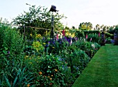 HALL FARM  LINCOLNSHIRE: HERBACEOUS BORDER WITH A SCULPTURE OF AN EAGLE BY PAUL GILBARD