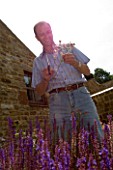 CLIVE NICHOLS PICKING FLOWERS IN HIS GARDEN
