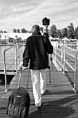 CLIVE NICHOLS WALKING OVER THE PONTOON AT HAMPTON COURT (BLACK AND WHITE IMAGE)
