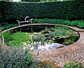 WINGWELL NURSERY  RUTLAND: CIRCULAR POOL (POND) WITH STONE SEAT AND WATER SCULPTURE NEW MOON BY GEORGE CUTTS