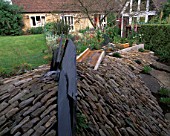WINGWELL NURSERY  RUTLAND: SLATE WATER SPOUT AND RILL LEADING OFF TOWARDS THE HOUSE. WATER FEATURE
