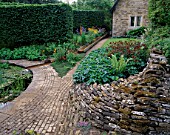 WINGWELL NURSERY  RUTLAND: VIEW TOWARDS THE HOUSE WITH STONE WALL AND PAVING  RILL  ASTRANTIAS AND FERNS