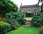 HALL FARM  LINCOLNSHIRE: VIEW OF THE HOUSE FROM THE DOUBLE HERBACEOUS BORDERS