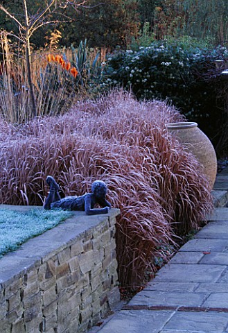 GARDEN_DESIGNED_BY_DUNCAN_HEATHER_TERRACOTTA_CONTAINER__STONE_WALL__BOY_SCULPTURE_AND_RHUS_IN_FROST_