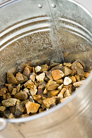 BARBEQUE_PROJECT_GRAVEL_PLACED_IN_BOTTOM_OF_METAL_BUCKET