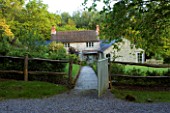 DESIGNER HELEN DOOLEY - ROSE COTTAGE  DORSET: VIEW OF THE COTTAGE FROM THE FRONT GATE