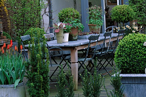 LISETTE_PLEASANCE_GARDEN__LONDONVIEW_TO_CONSERVATORY_WITH_DECKED_TERRACE__LEAD_TABLE_AND_CHAIRS