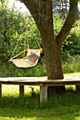 DESIGNER CLARE MATTHEWS: HANGING SEAT MADE FROM DOWEL AND CANVAS HANGS OFF A TREE