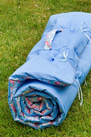 DESIGNER_CLARE_MATTHEWS_BED_ROLL_ON_LAWN_SHOWING_HANDLE
