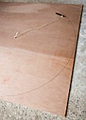 DESIGNER: CLARE MATTHEWS - DRAWING OUT A CIRCLE ON PLYWOOD SHEET