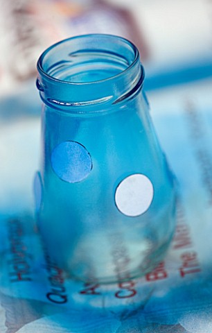 DESIGNER_CLARE_MATTHEWS___LANTERN_STAND__PAPER_CIRCLES_REMOVED_FROM_BLUE_PAINTED_GLASS_JAR