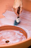 DESIGNER: CLARE MATTHEWS - BUBBLING BOWL WATER FEATURE PROJECT: PAINTING FILLER ONTO TERRACOTTA POT