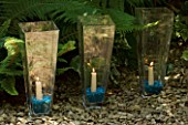 DESIGNER: CLARE MATTHEWS - GLASS CANDLE HOLDERS LINING A PATH
