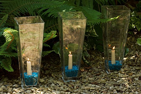 DESIGNER_CLARE_MATTHEWS__GLASS_CANDLE_HOLDERS_LINING_A_PATH