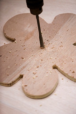 DESIGNER_CLARE_MATTHEWS__FLOWER_SWING_SEAT_PROJECT__DRILLING_A_HOLE_THROUGH_PLYWOOD_FLOWER_SEAT